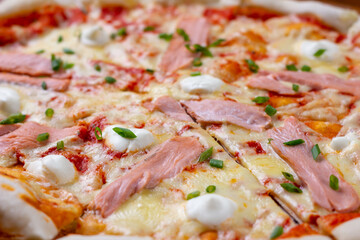 Close up of hot pizza with salmon and cheese