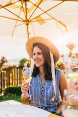 Outdoors portrait of a beautiful woman drinking wine in winery