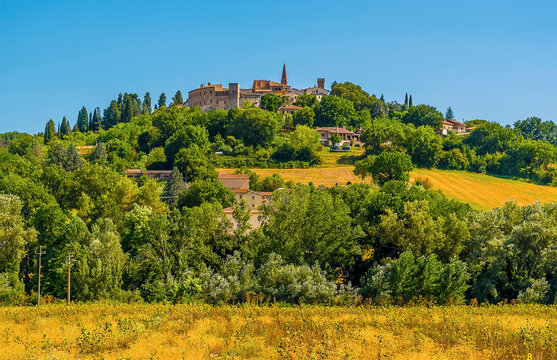 The hill top village of  Collazzone near Todi, Italy peeks out above the trees in the summertime