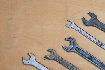 Old spanners on a wooden background