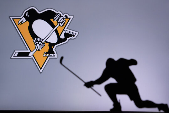 TORONTO, CANADA, 17. JULY: Pittsburgh Penguins Logo. Professional NHL hockey player celebrate goal. Silhouette photo, Edit space