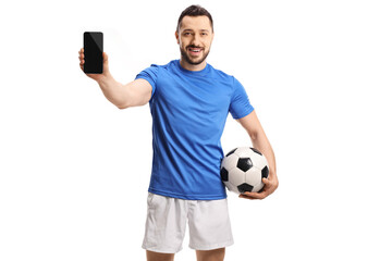Soccer player holding a football and a mobile phone