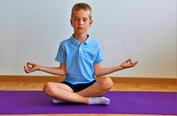 boy meditates sitting in lotus position