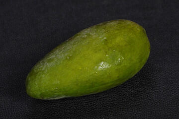 Green tasty mango over wooden background