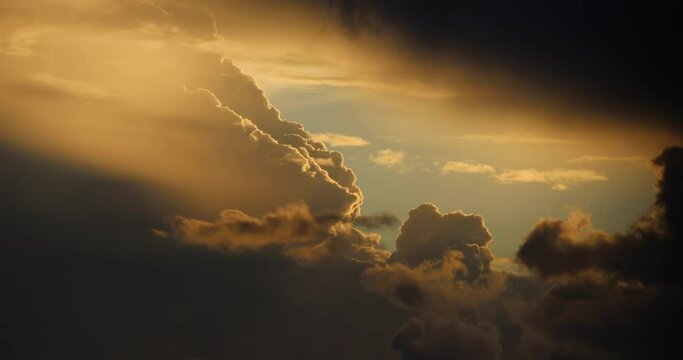 Large clouds loom overhead on a partly cloudy sunset.