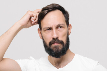 Fototapeta premium Studio portrait of man with short haircut standing over pink background with crossed arms on his chest