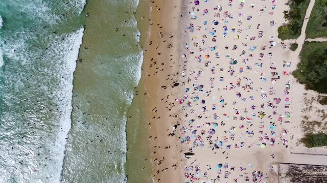 Aerial shot of the biscarrosse beach during the high summer season with lots of people crowded on the beach