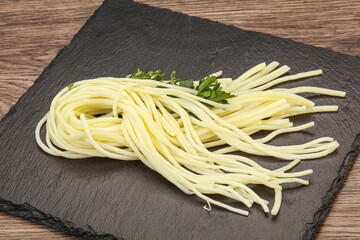 Chechil spaghetti cheese over board