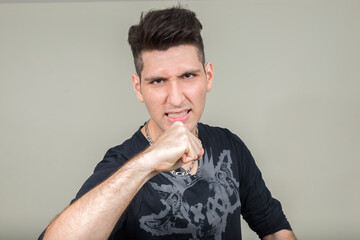 Portrait of stressed young multi ethnic man ready to fight