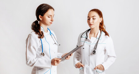 Medical documents. Two doctors with stethoscope at hospital. Nurse hold patient medical chart. Information data. Therapist in uniform. Medical history prescription. Woman work at clinic.