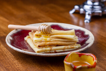 Pancake breakfast for tea. Homemade pancakes with honey on wood background. Delicious, healthy, tasty food. Holidays, recipe concept.
