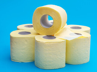 Stack of rolls of toilet paper on blue.