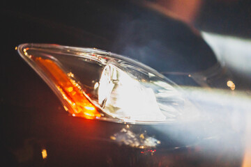 Fototapeta na wymiar Car Headlights Close-up with Atmospheric Smoke..