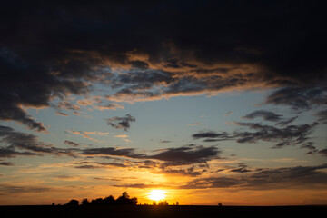 Epic landscape at sunset. Tragic gloomy sky. Fantastic skies on the planet earth. Crimson twilight. Panorama.