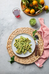 Pasta Lorighittas of Sardinia. Loriguittas with herb sauce pesto. in White plate.