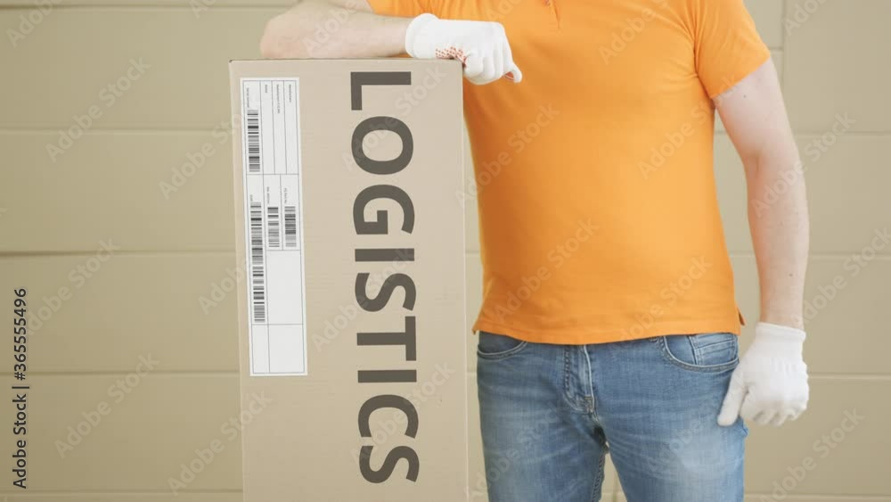 Poster warehouse worker with big parcel with printed logistics text and label on it