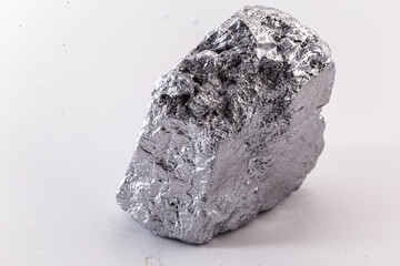 Macro shot of nickel metal ore piece isolated on a white background. Closeup photo of surprising...