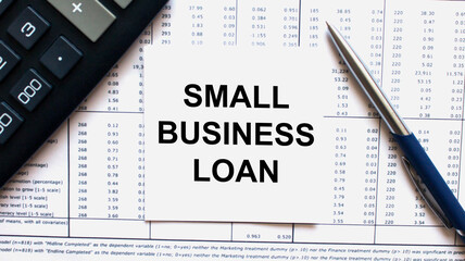 Work smarter text Small Business Loan on white sheet with pen, calculator and tables
