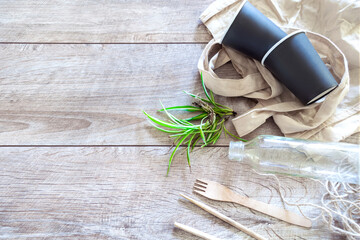 Eco friendly disposable kitchenware utensils on wooden background. ecology, recycling, zero waste, no plastic concept.