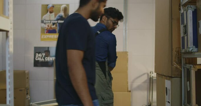 Workers placing road cases on shelves