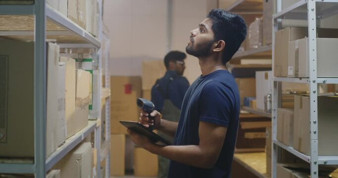 Workers checking boxes in a distribution center