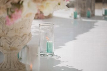 Beautiful bouquet of roses in a vase on a background of a wedding arch. Beautiful set up for the wedding ceremony.