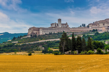 Fototapeta na wymiar A view towards the town of Assisi, Umbria, Italy and the Basilica of Saint Francis in the summertime