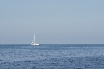 Obraz premium View of a white yacht over the calm blue sea