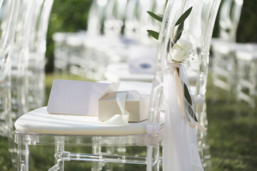 White transparent chairs at the wedding ceremony
