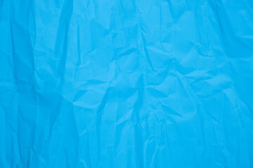 Close up of blue crumpled empty sheet of paper.