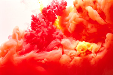 Red and yellow inks making clouds in water