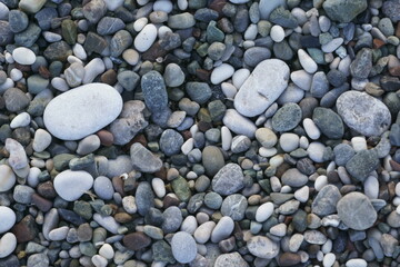Closeup view of small stones on the beach with colorful pattern