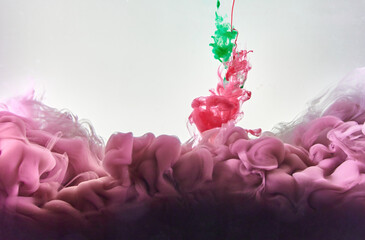 Red and green ink making clouds in water