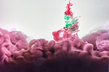 Red and green ink making clouds in water