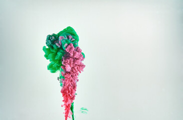 Red and green ink making clouds in water