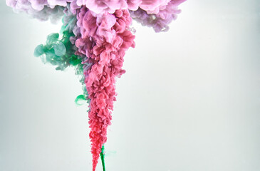 Red and green ink making clouds in water