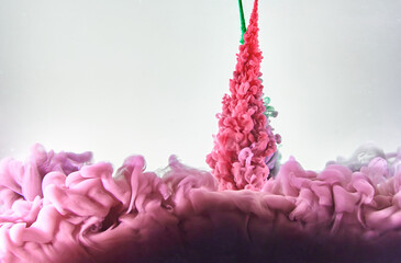 Red and green ink making clouds in water