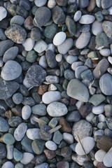 Closeup view of small stones on the beach with colorful pattern