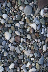 Closeup view of small stones on the beach with colorful pattern