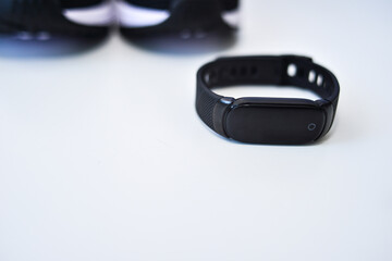Sports black shoes and watches for monitoring your health on a white background