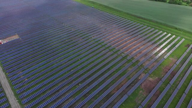 Arial Footage Of Solar Power Panels Farm. Green Energy, Renewable Energy, Alternative Energy Concept. Innovative Solar System In The Field. Drone View 4K.