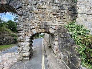 Small arch, part of the larger aqueduct, that spans the road at Bolton Abbey, Skipton, UK
