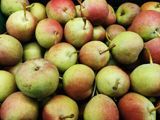 green pears with red sides on the supermarket window, summer fruit, vitamin season