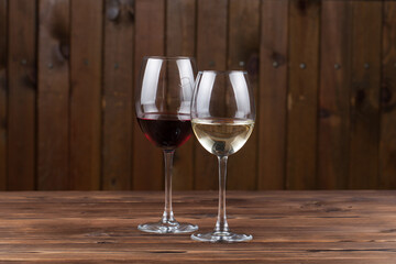white and red wine on a wooden background