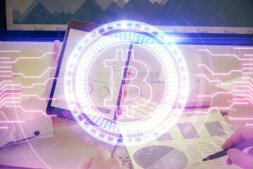 Double exposure of man's hands holding and using a phone and crypto currency blockchain theme...