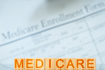 medicare concept. wooden blocks with the inscription on the background with Medicare enrollment form
