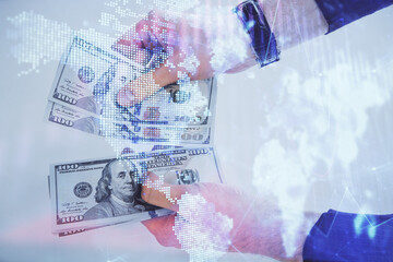 Multi exposure of financial graph drawing hologram and USA dollars bills and man hands. Analysis concept.