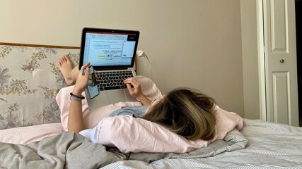 woman using laptop And phone working or learning from home due to covid-19 pandemic social...