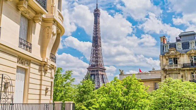 Romantic cozy view of the famous Eiffel tower from a small paris street on a cloudy sunny day in spring summer - wide horizontal panorama.From the Avenue de Camoens