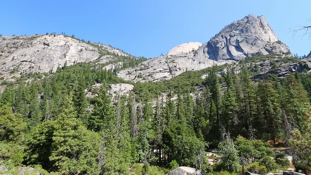 Panorama of Half Dome, Mt Broderick and Liberty Cap peaks on Mist trail in Yosemite National Park. Summer travel in California, United States.